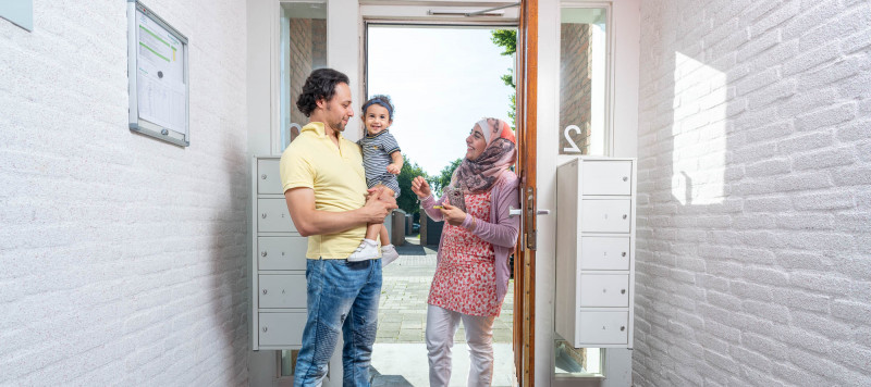 Foto van een gezin dat bij de voordeur van een appartementencomplex staat in Gorinchem